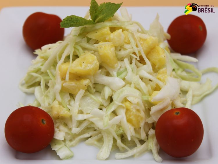 Salade de chou avec ananas et tomates cerise sur une assiette blanche