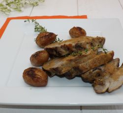 Rôti d'échine de porc au four avec du thym, pommes de terre et une belle sauce