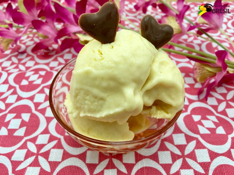 Une coupe de crème glacée à la mangue décorée avec 2 cœurs en chocolat